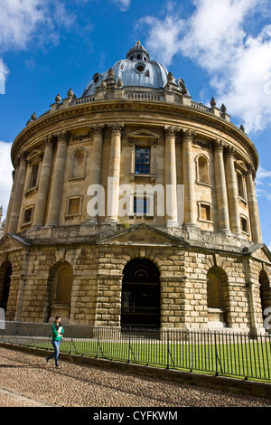 Female student walking past Radcliffe Camera Oxford Oxfordshire England Europe Stock Photo