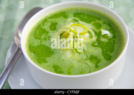 White bowl of bright green pea soup. Stock Photo