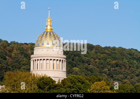 The golden West Virginia State Capital Dome towering above the trees on an clear, Fall evening, at sunset in Charleston, WV, USA Stock Photo