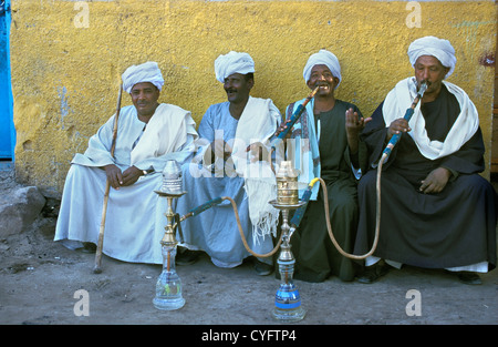 Egypt, Aswan. Men relaxing, smoking water pipe. Stock Photo