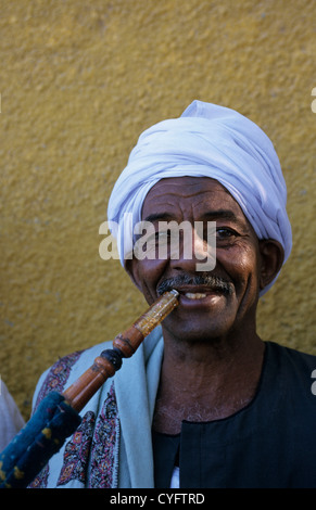 Egypt, Aswan, Nile valley, Portrait of Nubian man smoking water pipe. Stock Photo