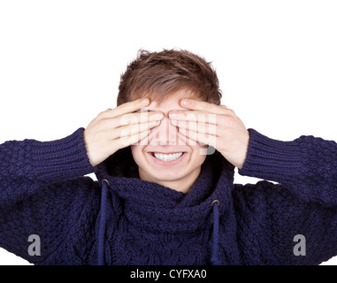 Laughing teenager in a purple sweater shut his eyes with his hands Stock Photo