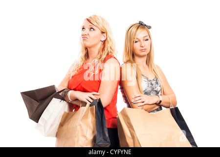 Two young blond unhappy women holding shopping bags, isolated on white background. Stock Photo