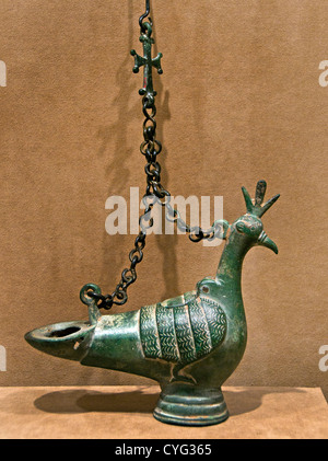 Hanging bronze oil lamp in the shape of a peacock with suspension chains and a Christian cross finial, Byzantine, 6th Century AD. Stock Photo