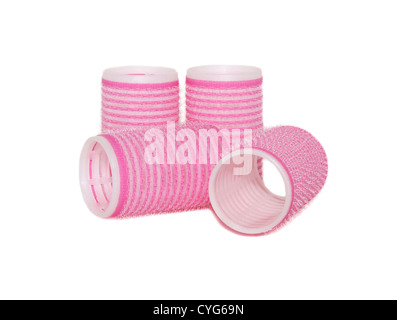 Four velcro rollers: two standing, two lying on their side, isolated on a white background Stock Photo