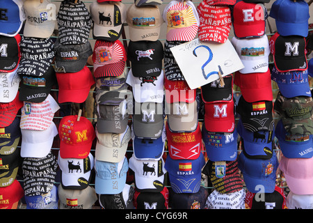 Brightly colored baseball caps for sale, El Rastro, Sunday street market, Madrid, Spain, Espana. Stock Photo