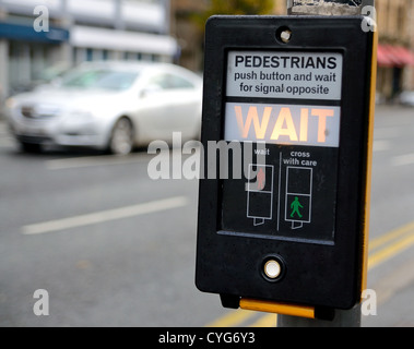 Crosswalk button for pedestrian with light warning. Stock Photo