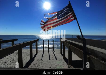 Nov. 4, 2012 - Queens, New York, U.S. - An American flag rises over the remains of the boardwalk in Far Rockaway following the effects of Hurricane Sandy, November 4, 2012. (Credit Image: © Bryan Smith/ZUMAPRESS.com) Stock Photo