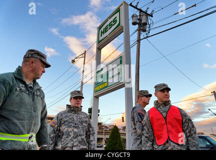 Nov. 3, 2012 - Merrick, New York, U.S. - U.S. Army National Guard members from Syracuse, NY, are at the Merrick Hess gas station, one of the Long Island gas stations open the Saturday after Hurricane Sandy battered this south shore area, to help Nassau County police maintain order in the long lines of people waiting their turn at the pumps. Stock Photo