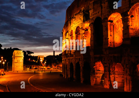 The Roman Colosseum at night .   Arch of Constantine in the background. Stock Photo