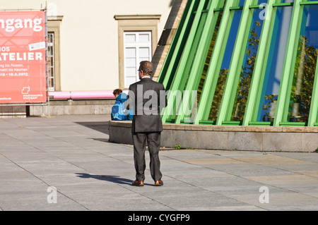 New State Gallery Stuttgart, South Germany – rich businessman walks towards older woman – Baden-Württemberg South Germany Stock Photo