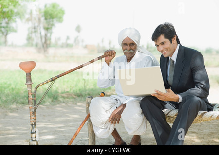 Financial advisor explaining to a farmer about agriculture loan Stock Photo