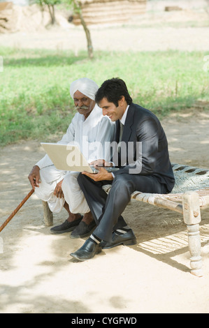 Financial advisor explaining to a farmer about agriculture loan Stock Photo