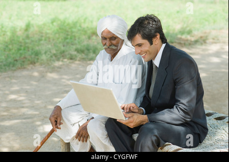 Financial advisor explaining to a farmer about agriculture loan Stock Photo