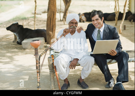 Financial advisor sitting with a farmer Stock Photo