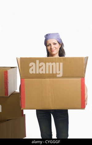 Portrait of a woman carrying a cardboard box Stock Photo