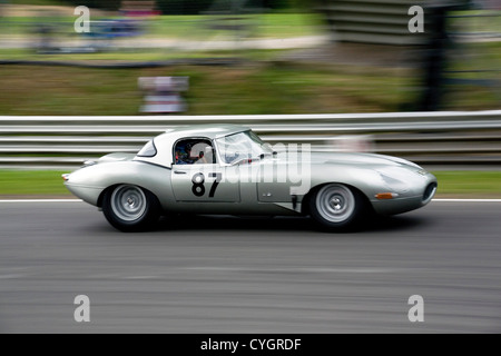 A grey Jaguar E-type hardtop classic racing car racing at Brands Hatch circuit. Stock Photo
