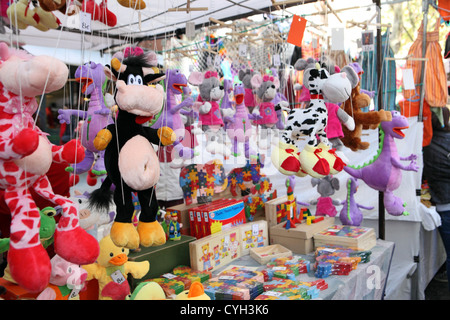 Puppets & children's toys for sale pavement stall El Rastro Sunday street market, Madrid, Spain. Stock Photo