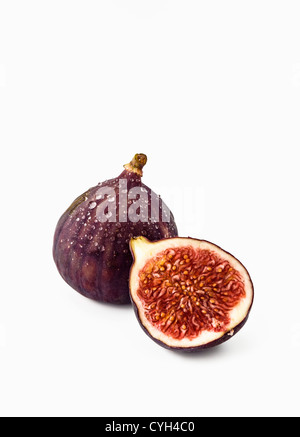 One whole fig and one cut in half Stock Photo