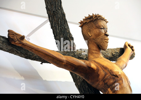 A wooden african statue of Jesus Christ on the cross with crown of thorns on his head, in a roman catholic chapel in Namibia Stock Photo