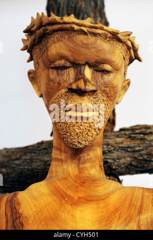 A wooden african statue of Jesus Christ on the cross with crown of thorns on his head, in a roman catholic chapel in Namibia Stock Photo