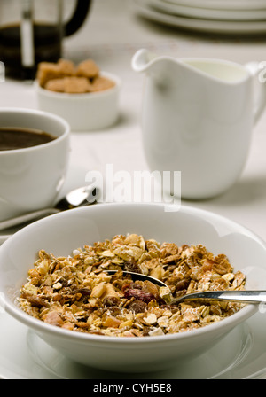 Breakfast setting of muesli with milk together with coffee and cream Stock Photo
