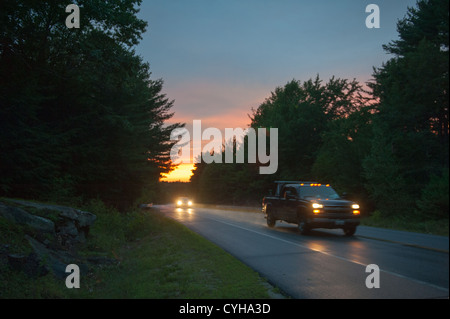 Sunset on the road and cars driving on New England Road trip Stock Photo
