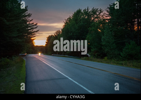 Sunset on the road and car driving on New England Road trip Stock Photo