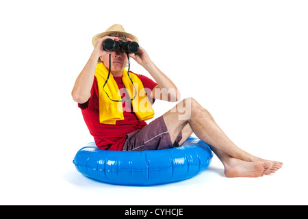 Tourist is sitting on float at the sea with binoculars Stock Photo