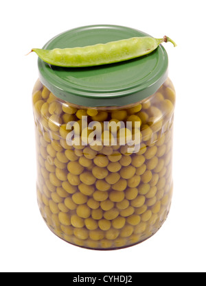 Pickled preserve pease in glass pot and fresh one on top. Food prepare for winter. Stock Photo