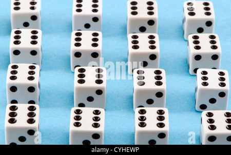 Lot of white gamble dice with six black dots on blue background. Stock Photo