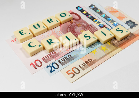 Euro notes and game tiles spelling the words Euro Crisis ...
