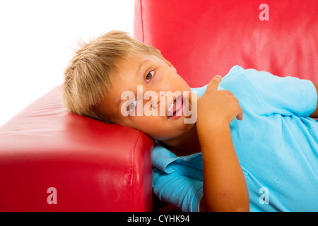 boy on red sofa Stock Photo