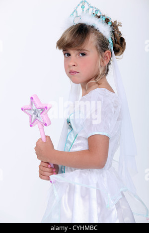 Little girl dressed as princess holding wand Stock Photo