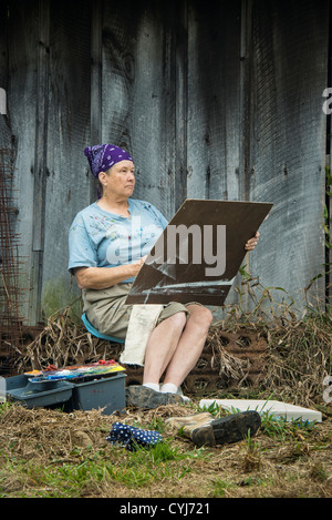 Plein air artist studies her subject. Stock Photo