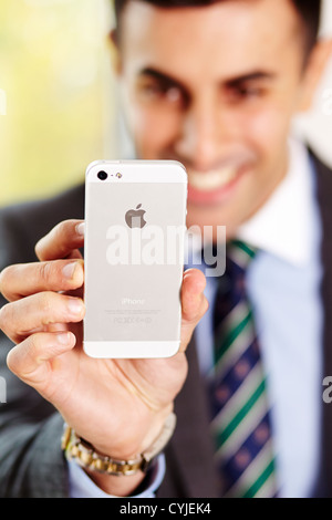 Man holding iPhone 5 Stock Photo