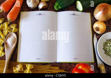 Top view of an empty recipe book surrounded of food ingredients and kitchen utensils Stock Photo