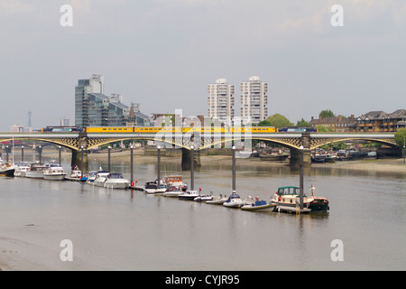 A test train crossing the Cremorne Bridge over the River Thames near Imperial Wharf in Chelsea London Stock Photo