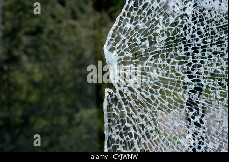 A broken window at a busstop caused bij vandalism Stock Photo