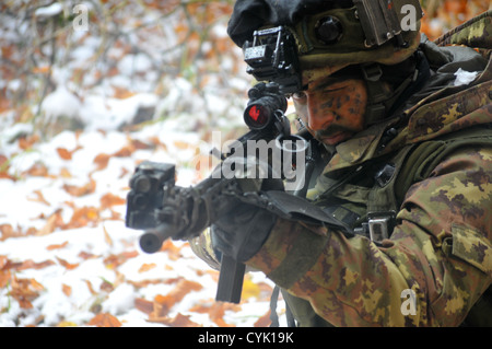 An Italian soldier from the 183rd Airborne Regiment aims his SCP70 assault rifle during a decisive action training environment exercise, Saber Junction 2012, at the Joint Multinational Readiness Center in Hohenfels, Germany, Oct. 28, 2012. Saber Junction Stock Photo
