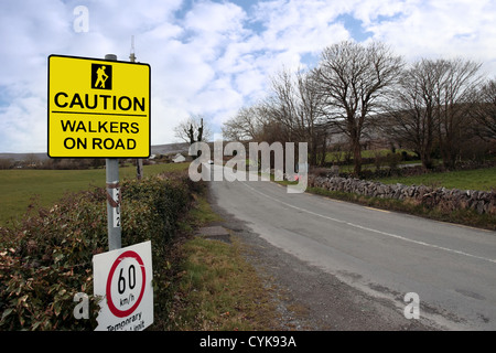 warning sign for drivers to be careful of tourists walking on country roads with 60 km/h speed limit Stock Photo