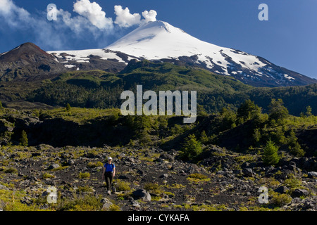 Villarrica National Park, Chile. South America. Woman hiker on active Villarrica Volcano. Sendero de las Cascadas. (MR) Stock Photo