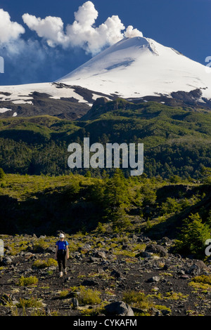 Villarrica National Park, Chile. South America. Woman hiker on active Villarrica Volcano. Sendero de las Cascadas. (MR) Stock Photo