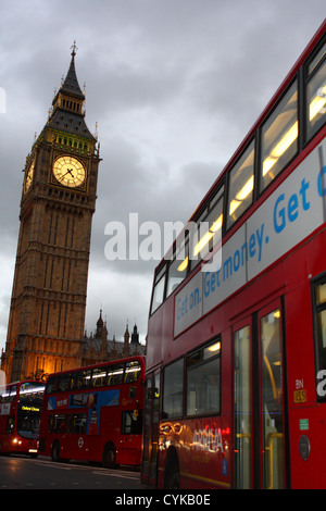 London buses traveling towards The Houses of Parliament with Big Ben in the distance Stock Photo