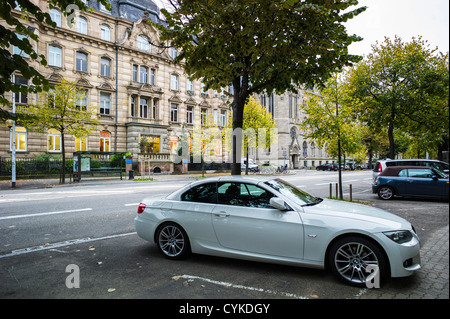 BMW car parked on pavement Strasbourg Alsace France Stock Photo