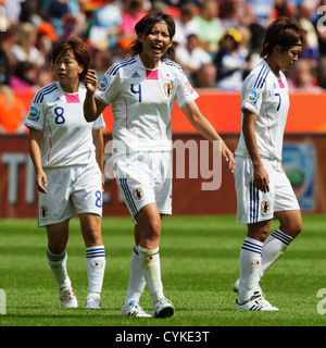 Japan team players Aya Miyama, Saki Kumagai and Kozue Ando (L-R) leave the pitch at halftime of a World Cup match v. Mexico. Stock Photo