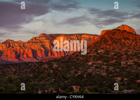 Sunset is very dramatic on the red rock hills surrounding Sedona, Arizona. Stock Photo