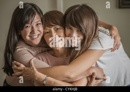 Grandmother, mother and daughter hugging Stock Photo