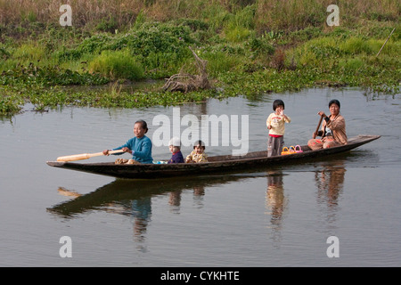 Myanmar, Burma. Mother and Children in Canoe, Paddling, Inle Lake, Shan State. Stock Photo