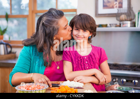 Mother and daughter cooking in kitchen Stock Photo
